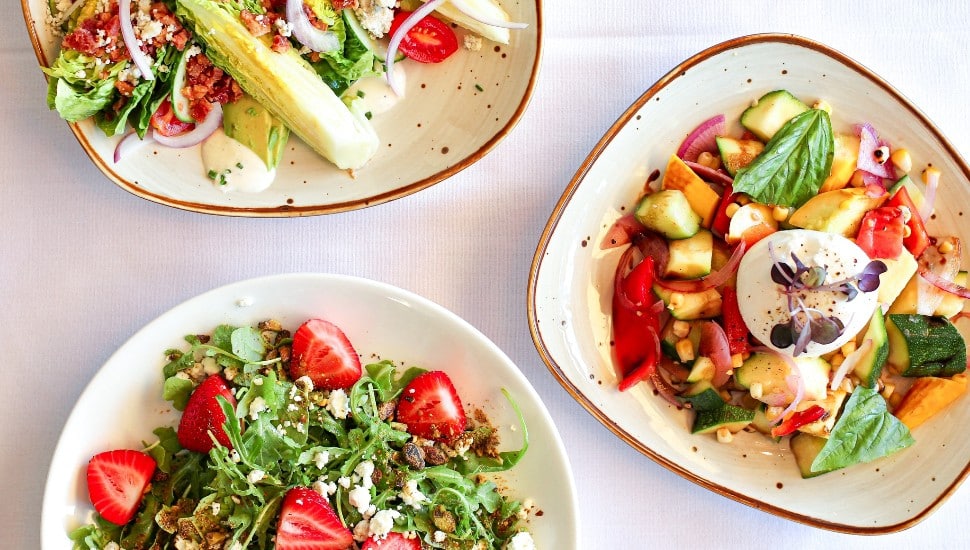 Three colorful salad dishes.