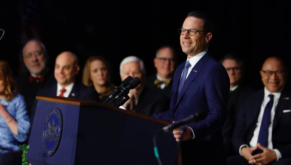 Josh Shapiro speaks to an audience from a podium.