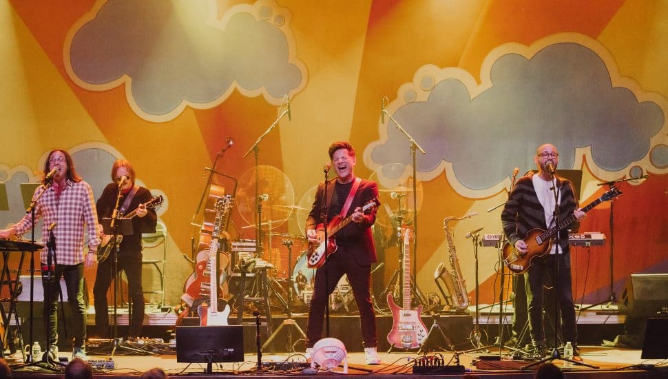 A photo of Yesterday and Today Beatles tribute band performing on stage.