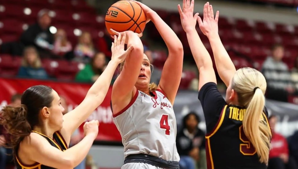 Laura Ziegler shoots a jump shot with double coverage.