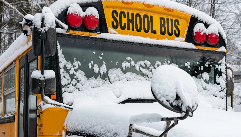 A school bus covered in snow.