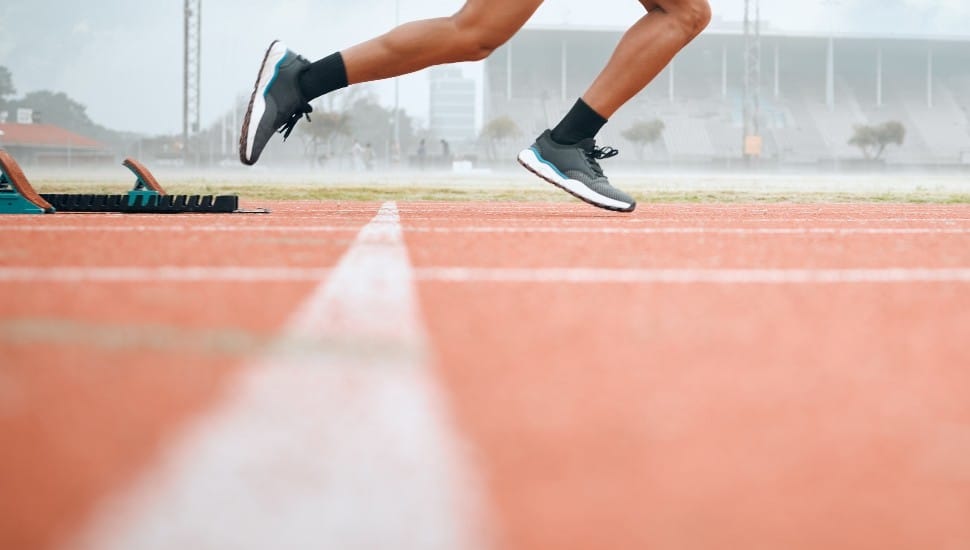 A race track with a runner starting.