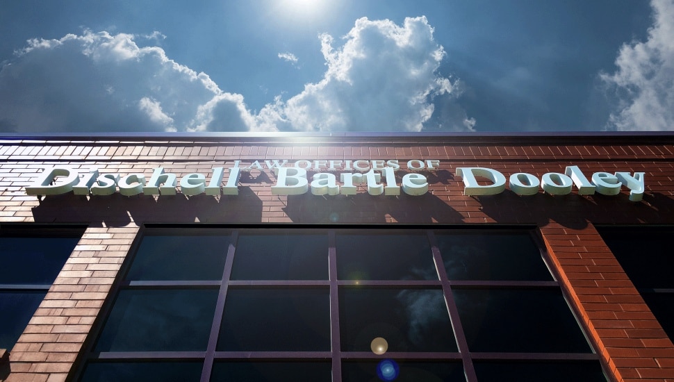 Law firm signage shines in the sun.