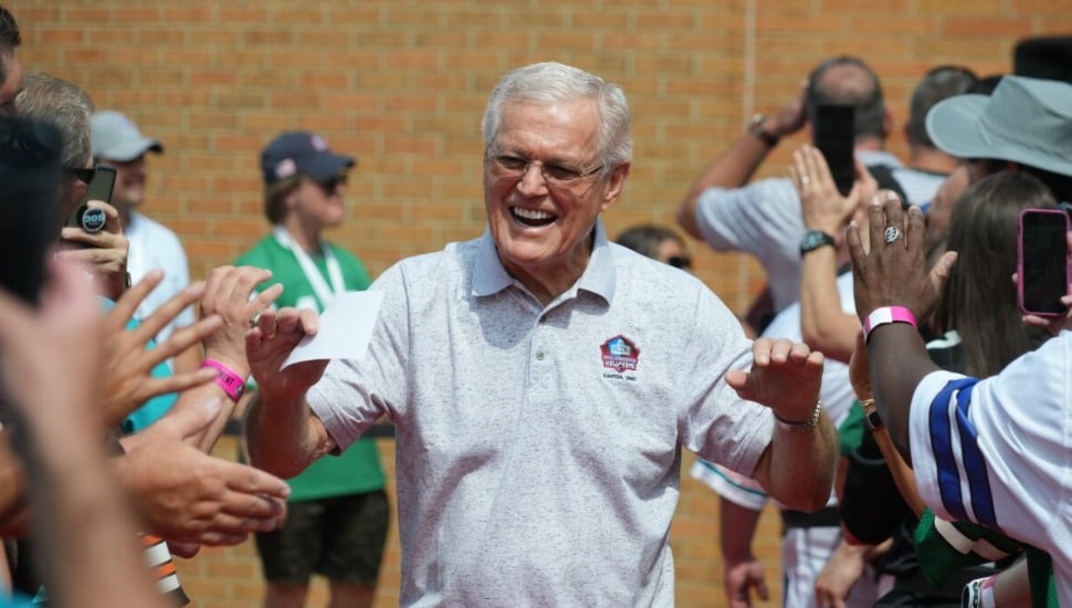 Dick Vermeil walking through people while giving high-fives.