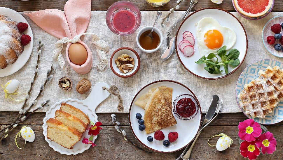 Easter breakfast or brunch set served on rustic wooden table