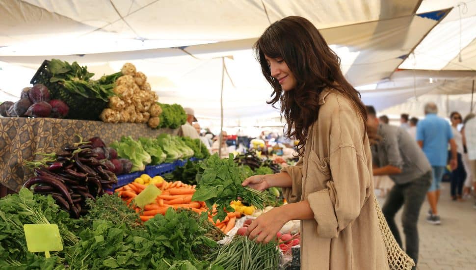 A woman shopping at a farmers' market.
