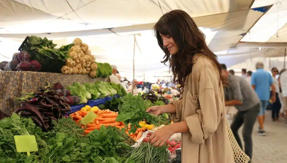 A woman shopping at a farmers' market.