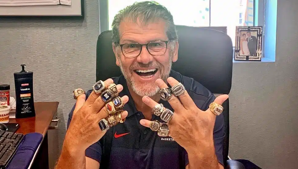 Geno Auriemma shows off his 11 championship rings.