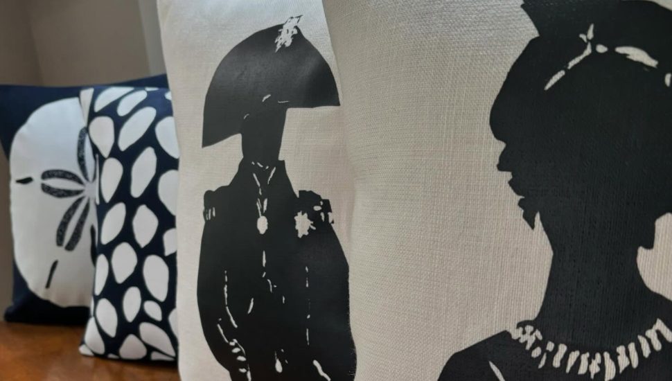 Three Kerry & Clyde pillows including one with a profile of Napoleon Bonaparte
