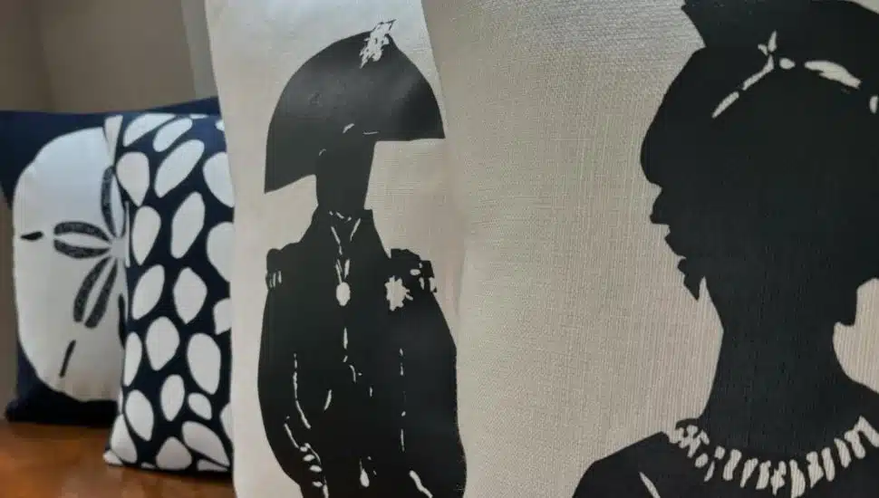 Three Kerry & Clyde pillows including one with a profile of Napoleon Bonaparte