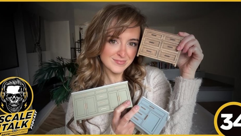 Kylie White poses with dollhouse dressers.