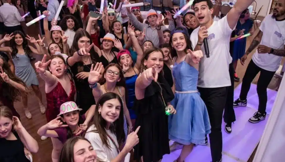 Ethan mazer with young kids at a bat mitzvah celebration.