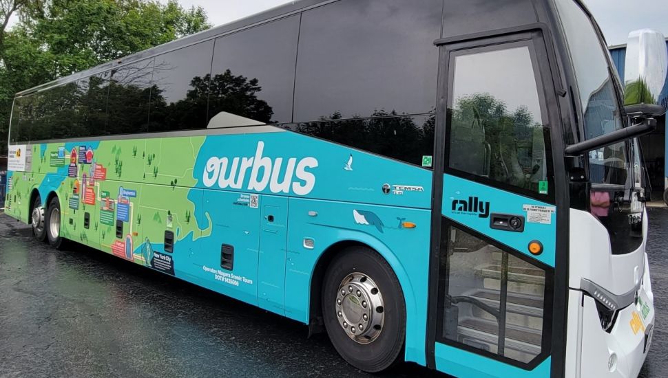 Blue and green-colored OurBus bus service.