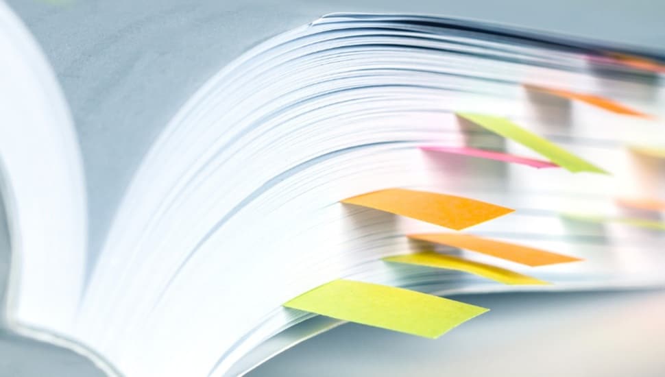 Open book with post-it notes.