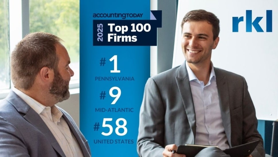 Accounting professionals smile as they talk business.