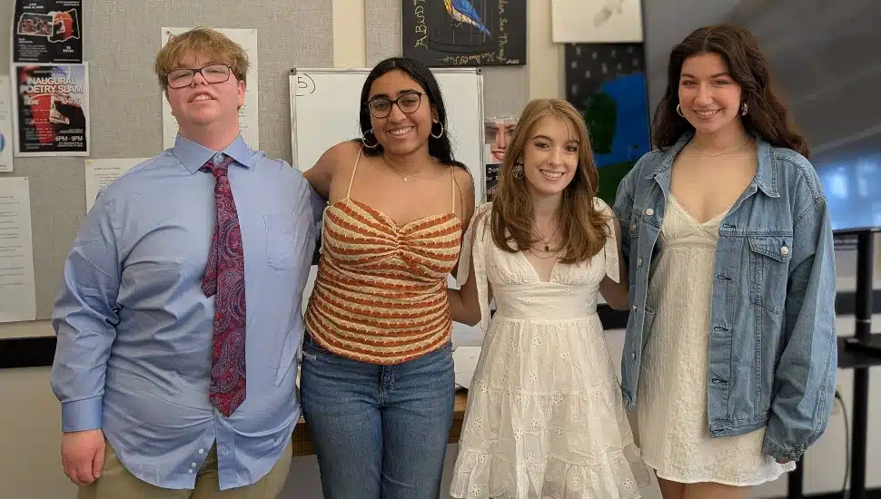 Group photo of four high school students who won journalism awards.
