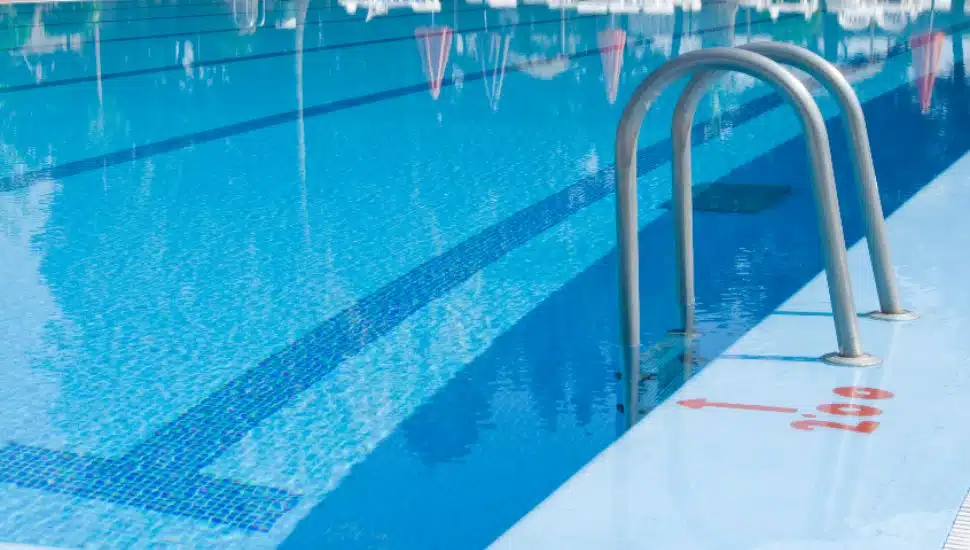 A ladder feeds into a public pool.