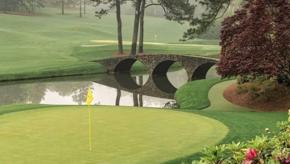 Overlooking a green and a bridge over water at Augusta National.