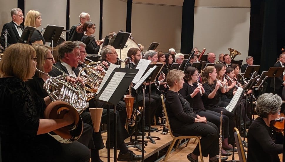 A Clarinet Choir plays at Immaculata University. The band of musicians is full and reading sheet music.