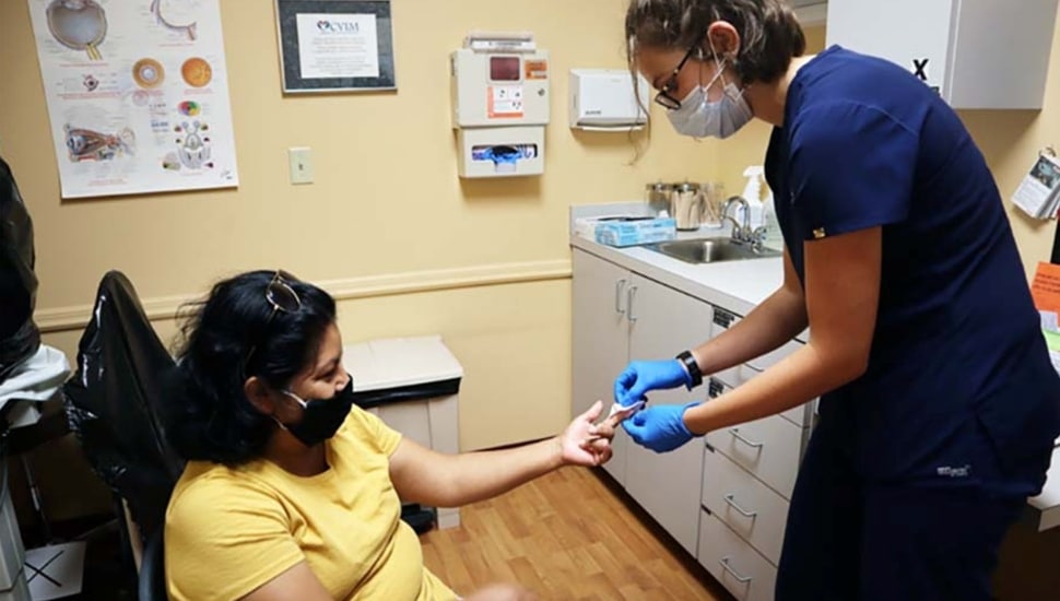A nursing intern treats a patient.