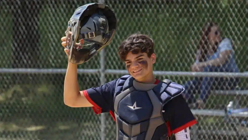 Jay Crater at home plate tipping his catcher's mask.