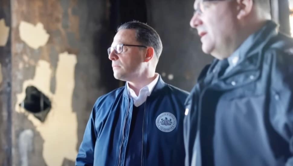 Josh Shapiro and police officer assess the fire damage at the Governor's Mansion.