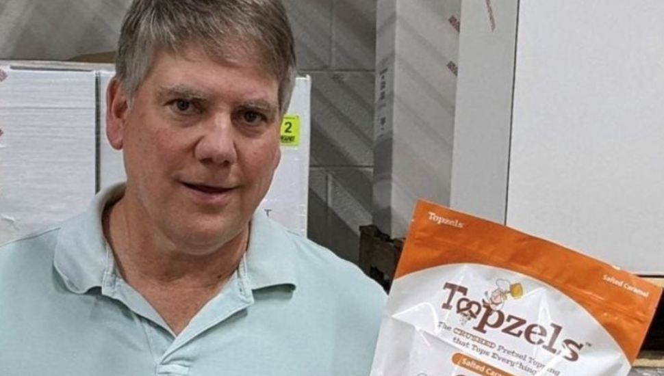 Karl Brown holding one of his Pretzel Pete products.
