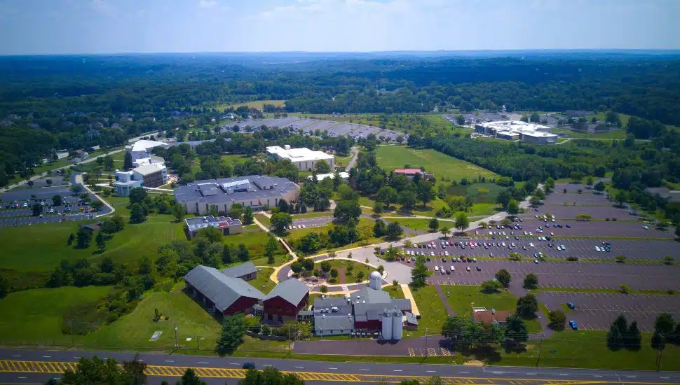 MCCC Blue Bell Campus. An aerial view showing lush green grass and trees with buildings, walkways.