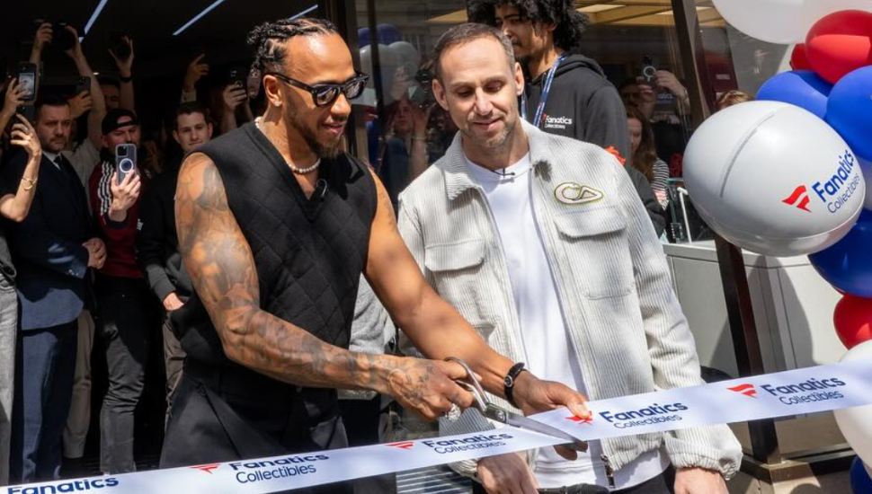 F1 Racer Lewis Hamilton and Michael Rubin cutting the ribbon at Fanatics store grand opening.