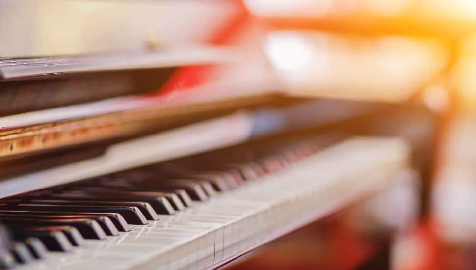 Beautiful piano background are set by the window in the morning waiting for the pianist to come to practice in the morning to reduce the mistake of having to perform the piano performance at a concert