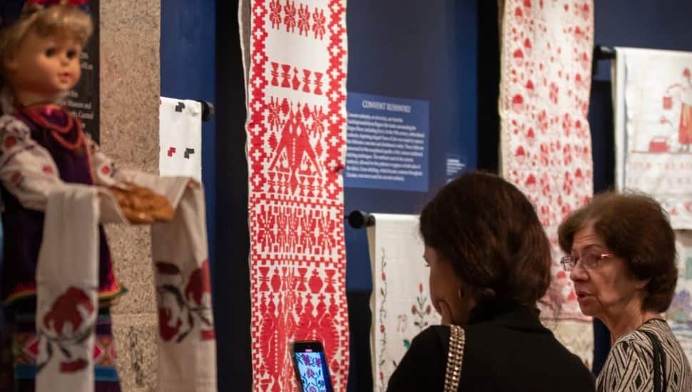 Two women visiting the Rushnyk exhibit at the Glencairn Museum.