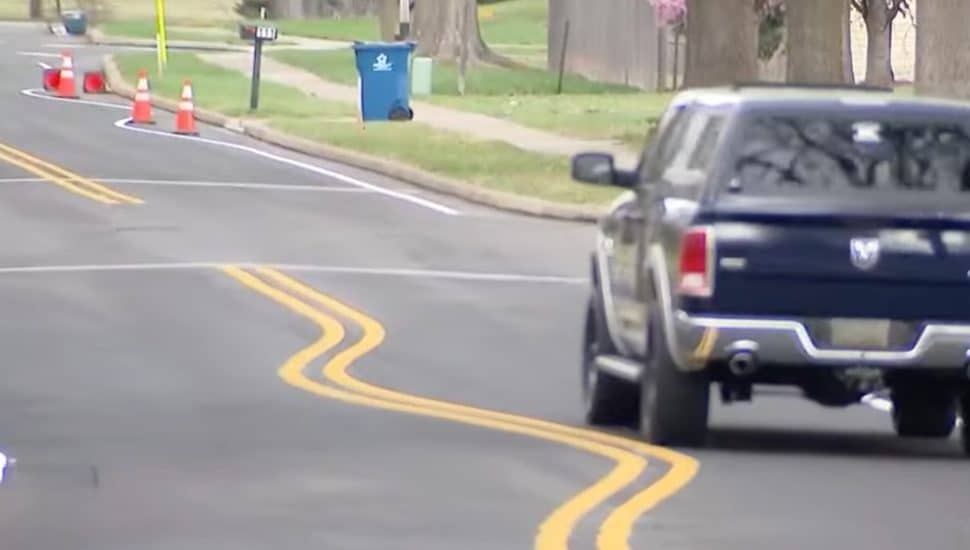 A truck driving down the road with wavy lines.