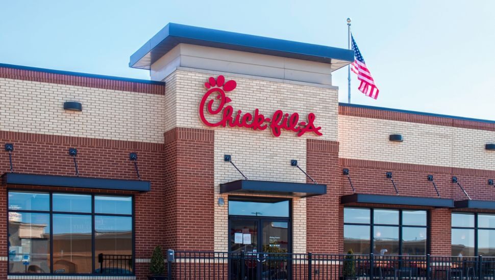 A Chick-fil-A restaurant. with an American flag.