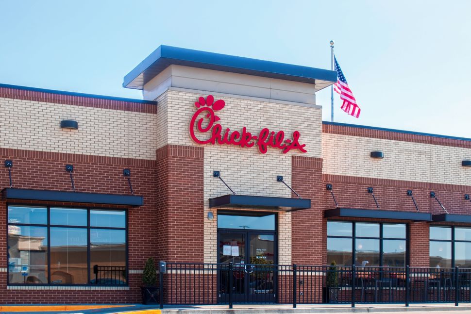 A Chick-fil-A restaurant. with an American flag.
