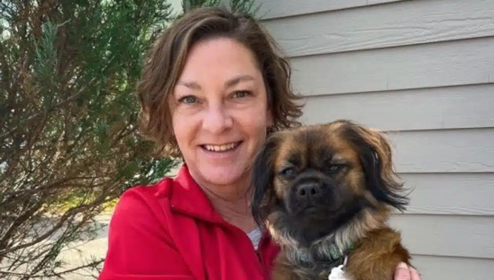 Abigail Smith holds her dog and smiles.