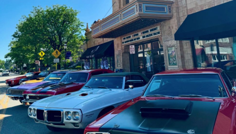 Classic cars lined up Butler Pike in front of the Ambler Theater.