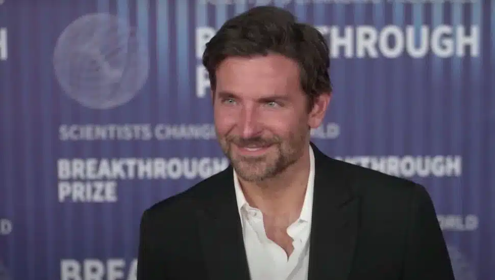 Bradley Cooper smiles on the red carpet.