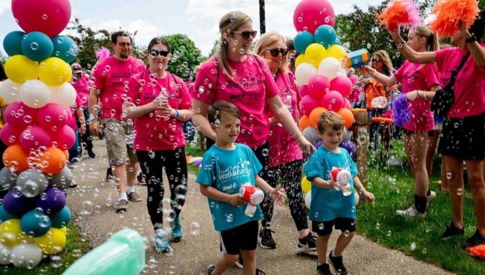 Jaclyn Urso-DeFeo and Family are showered with bubbles during the May 18 Arc Bubble Walk & Fun Day. Bubble Walk.