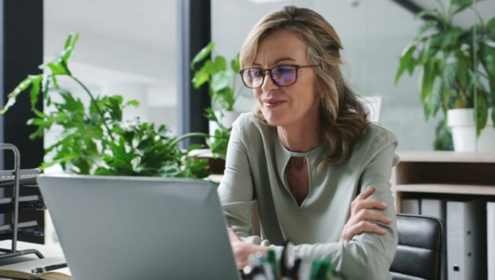 Female business owner works on her laptop computer.