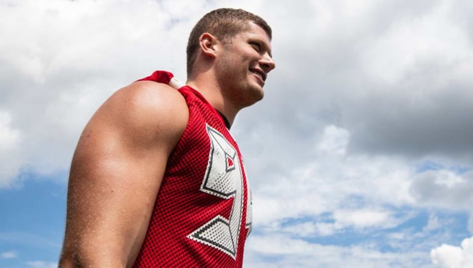 Carl Nassib with sky in backgroud, side profile.