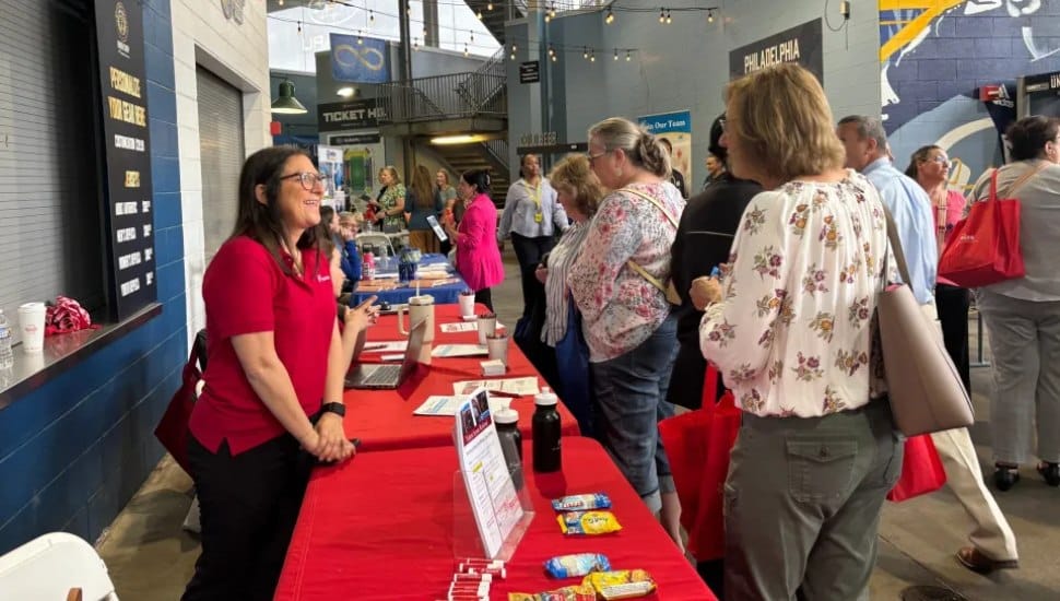 Renee Morrison of Bayada Nurses greets former Crozer Health employees Tuesday at the Crozer Rapid Response Employment and Resource Fair with her colleague, Moira Winterstein.