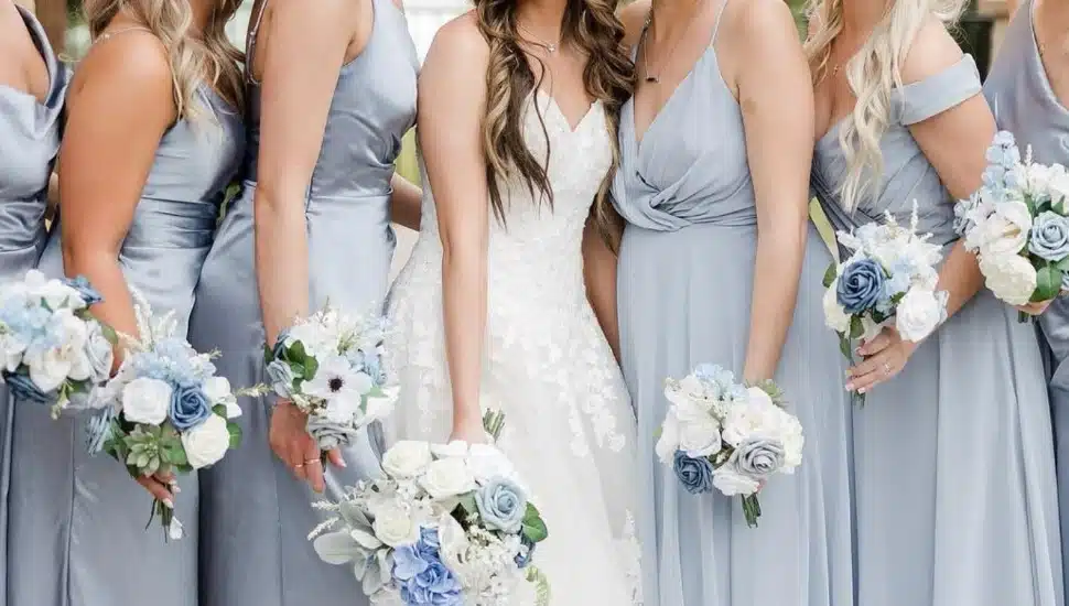 A focus on the dresses of a bride and her bridesmaidss.