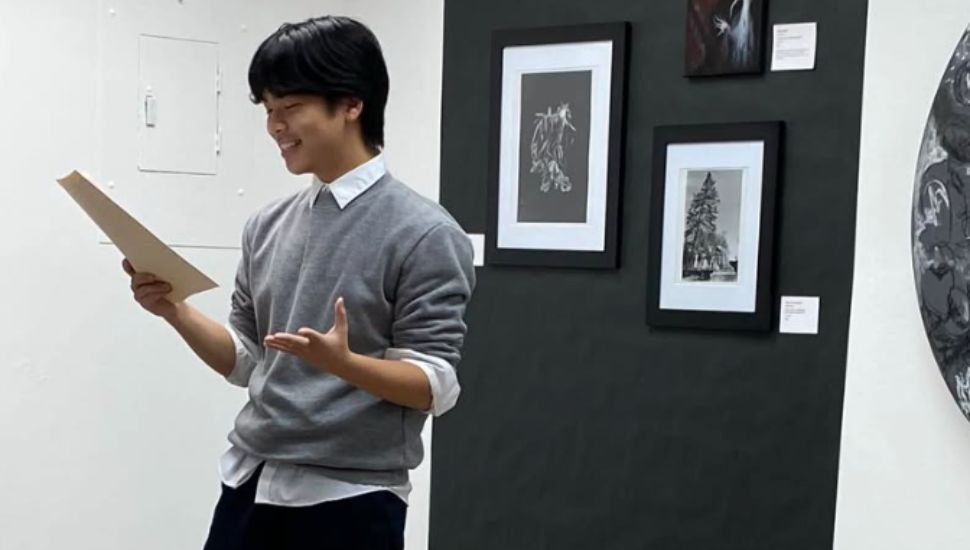 Evan Wang recites a poem in front of class.