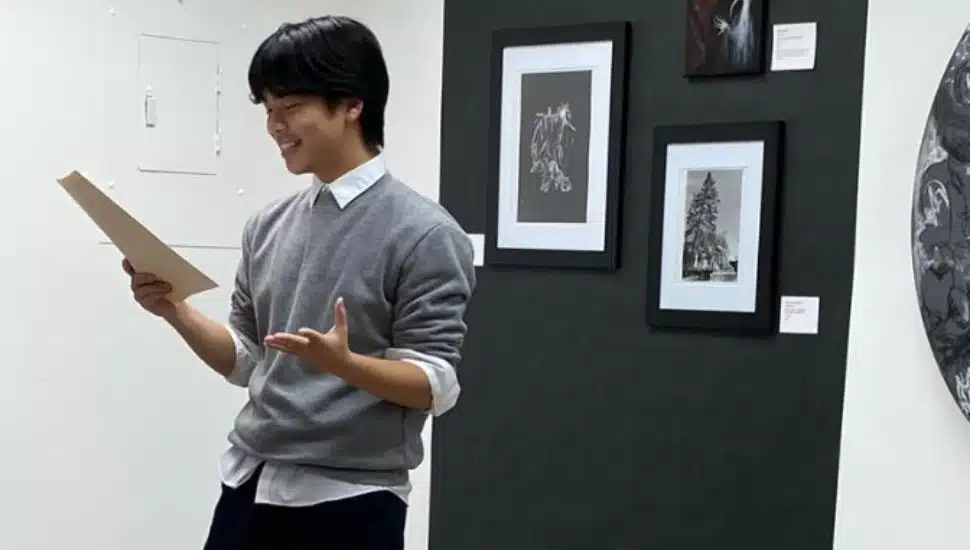 Evan Wang recites a poem in front of class.
