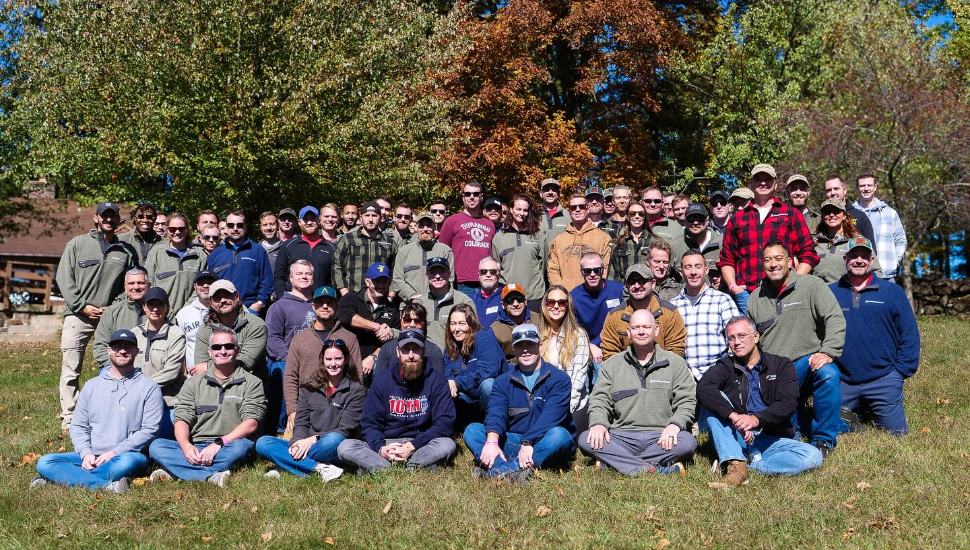 Greencastle Consulting team all pile in for outdoor photo.
