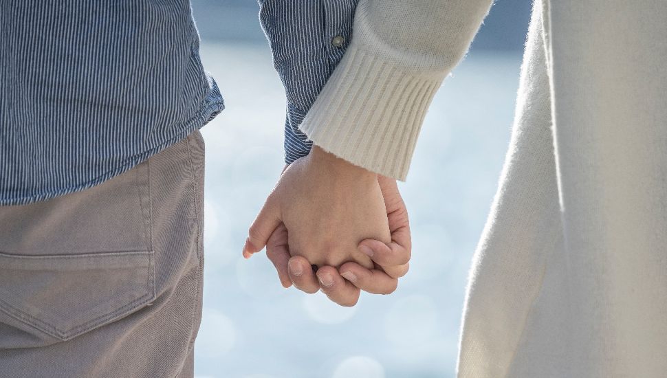 A man and woman holding hands.