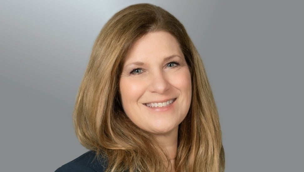Headshot of white female business executive with brown hair.