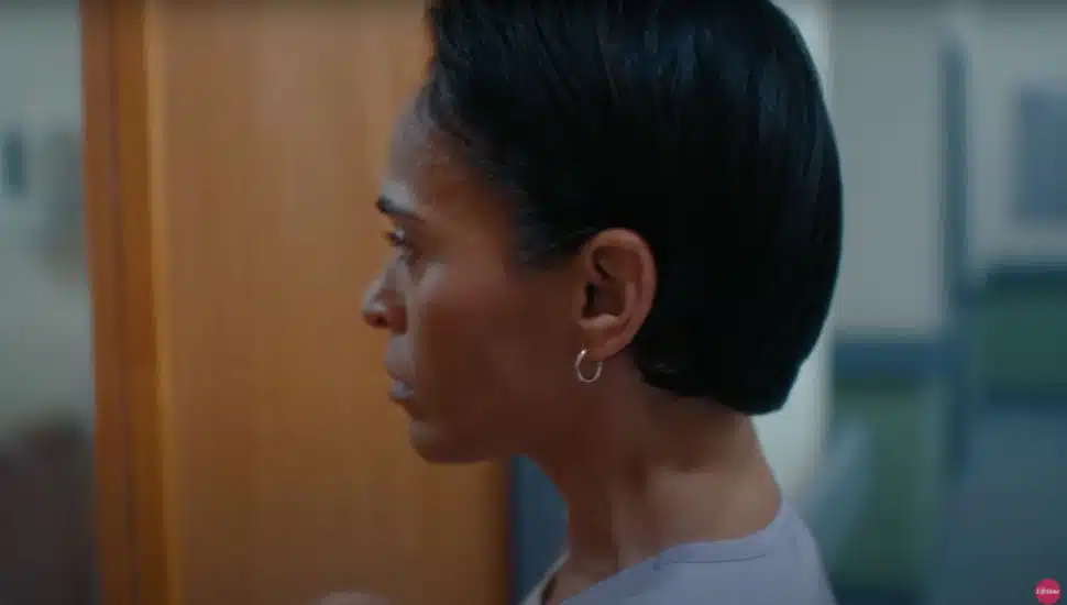 Actress looks through hospital door in 'Pretty Hurts' film.