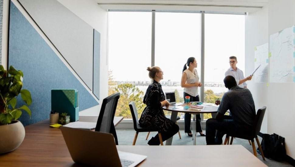 Workers discuss business strategy in conference room.