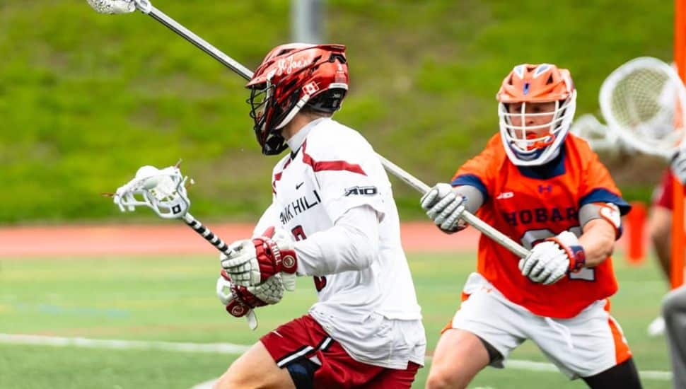 St. Joe's lacrosse player maneuvers around a defenseman.